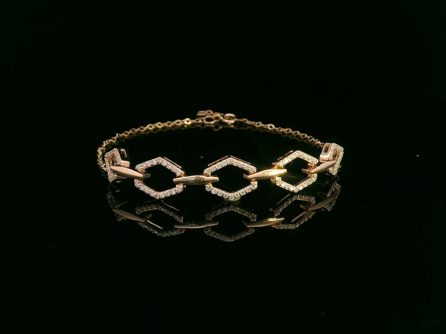 18K gold bracelet with five diamond-encrusted hexagon links and chain-link design