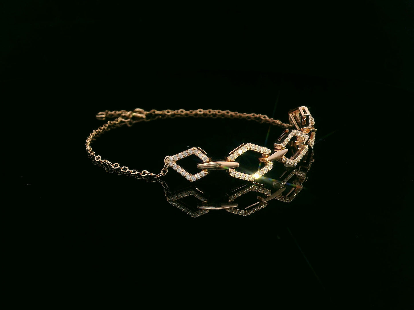 18K gold bracelet with five diamond-encrusted hexagon links and chain-link design