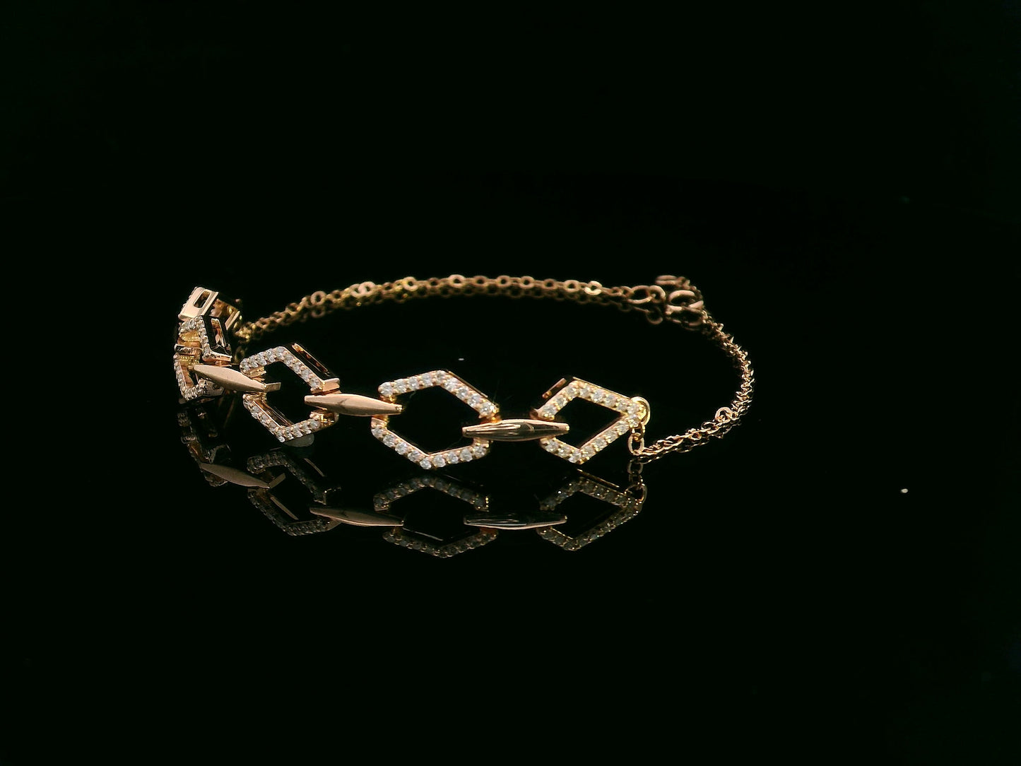 18K gold bracelet with five diamond-encrusted hexagon links and chain-link design