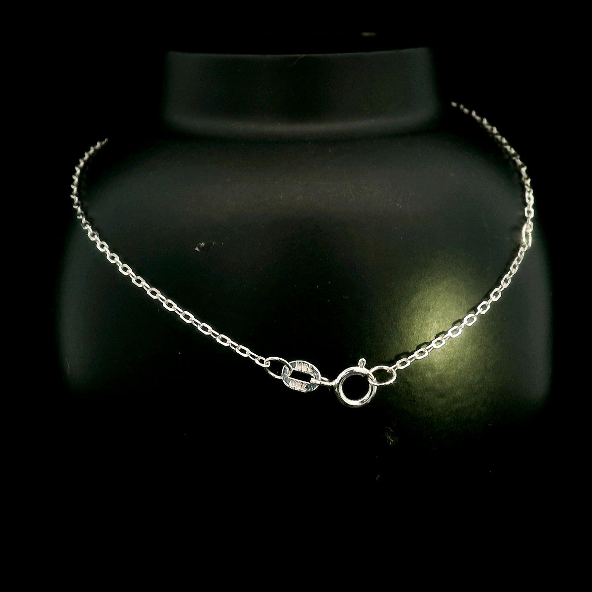 Diamond bar bracelet in 18K white gold featuring a curved row of round brilliant diamonds on a fine chain.