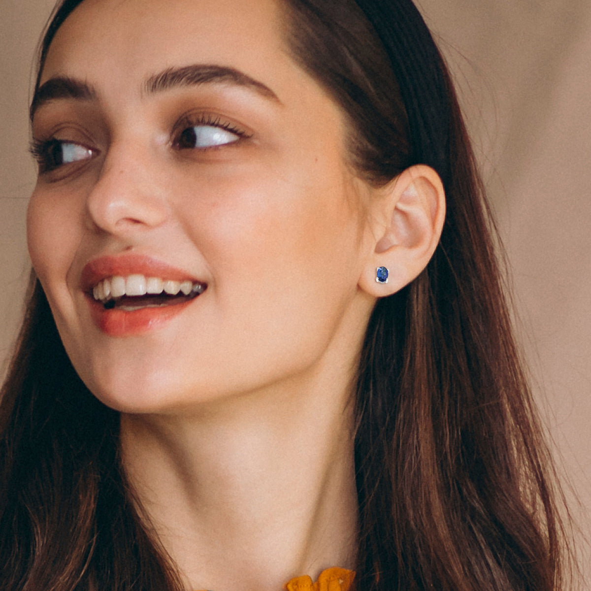 18K gold oval Tanzanite earrings featuring 0.62 carats of vibrant December birthstone in a dainty minimalist design – perfect for stacking and everyday wear.
