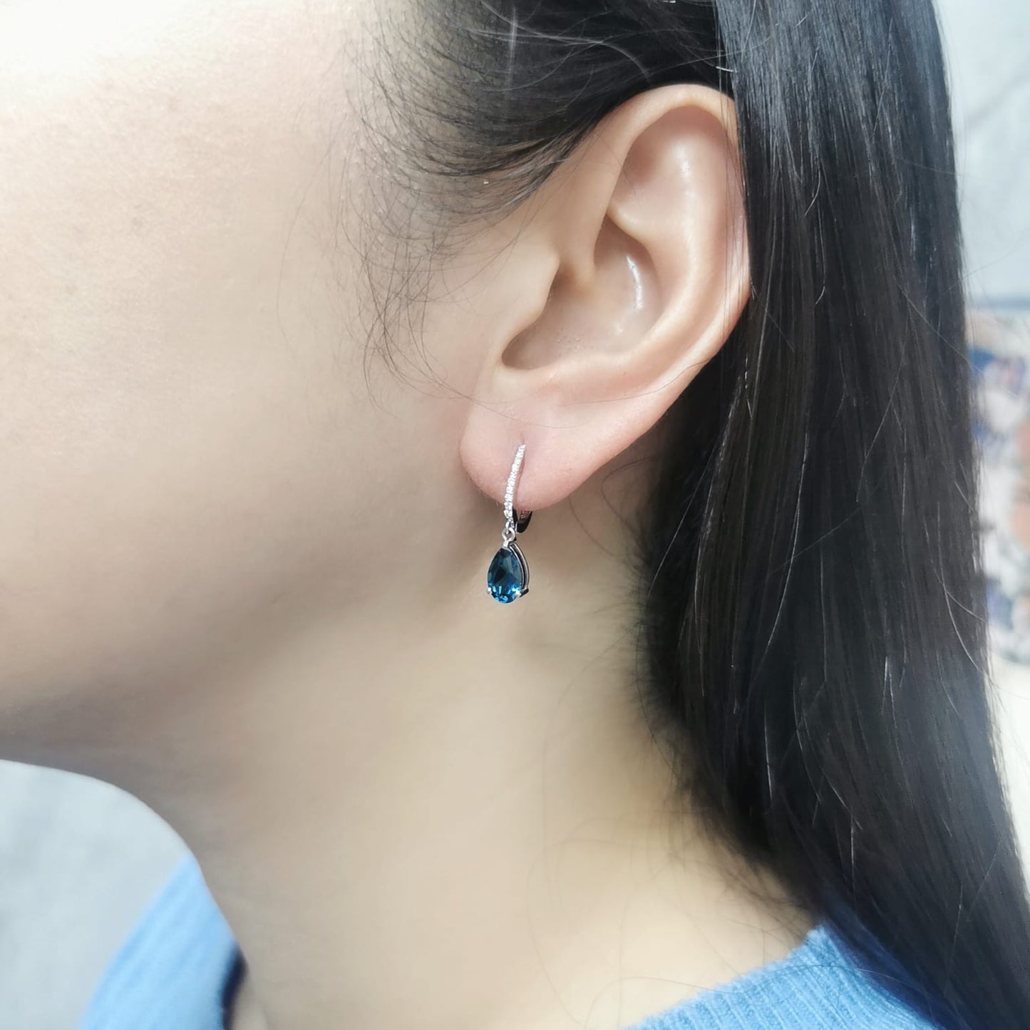 18K gold drop earrings featuring pear-cut London Blue Topaz (1.94 carats) with round-cut diamonds (0.08 carats), set in elegant diamond-studded huggie hoops.