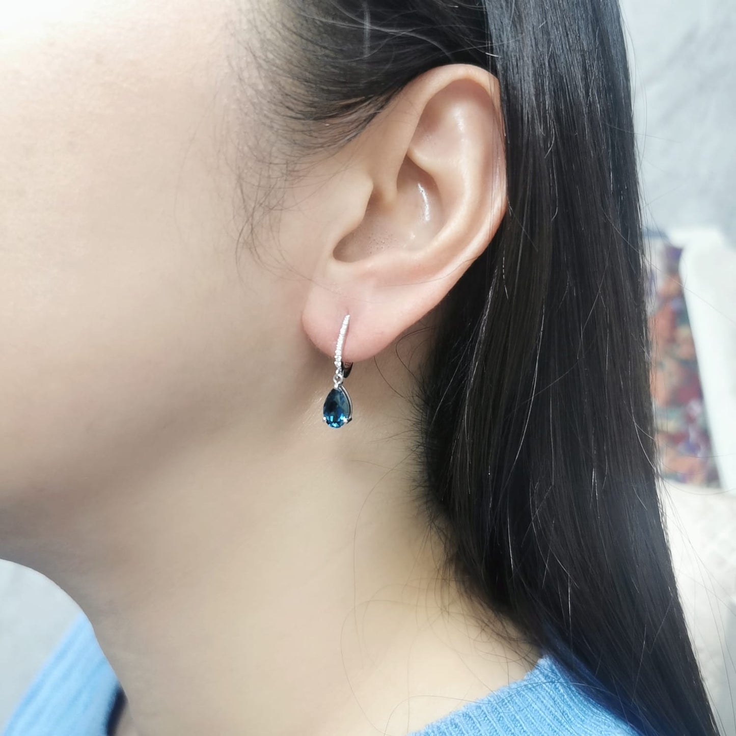 18K gold drop earrings featuring pear-cut London Blue Topaz (1.94 carats) with round-cut diamonds (0.08 carats), set in elegant diamond-studded huggie hoops.