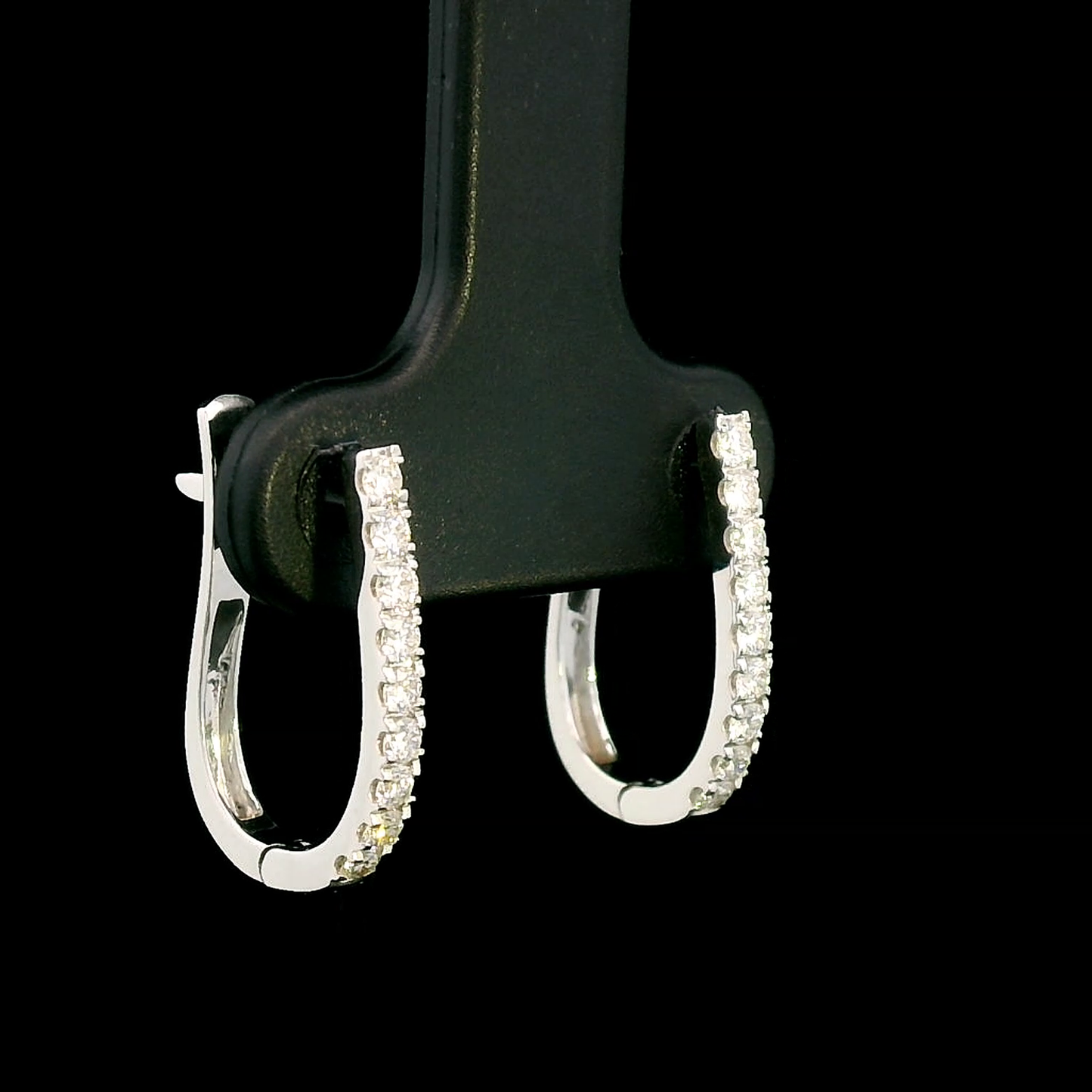 18K gold diamond huggie hoop earrings featuring 0.31 carats of round-cut diamonds in a sleek, elegant design – perfect for any occasion.