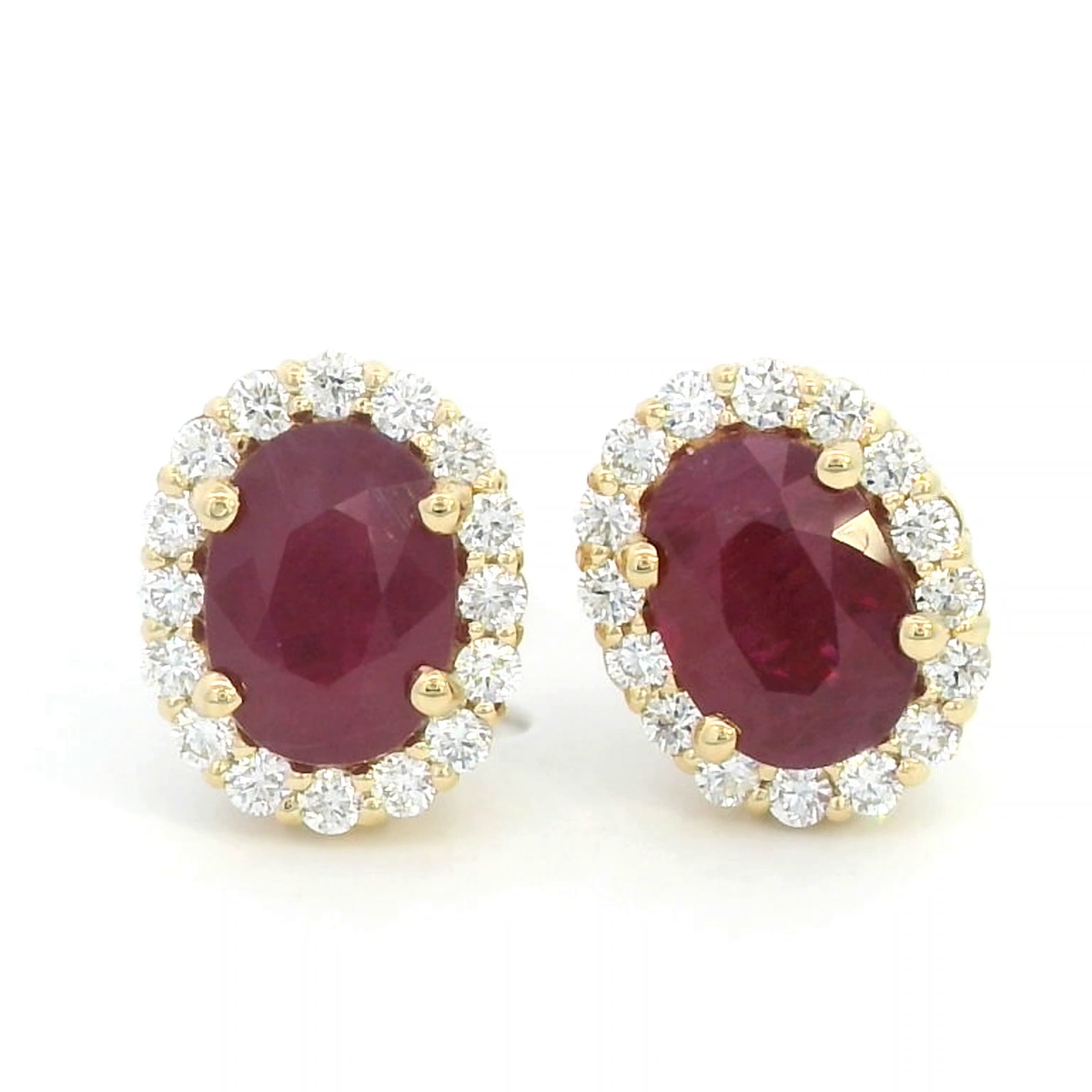Oval Ruby With Diamond Halo Earrings In 18k Yellow Gold.