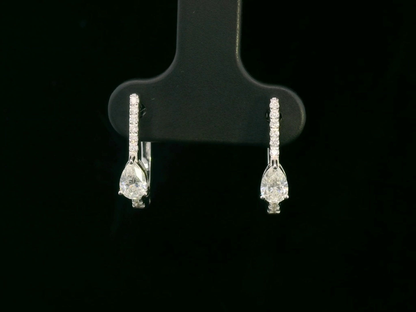 A pair of 18K gold hoop earrings featuring pear-shaped diamonds (0.41ct total) and accent diamonds (0.09ct total), elegantly designed for a timeless look.