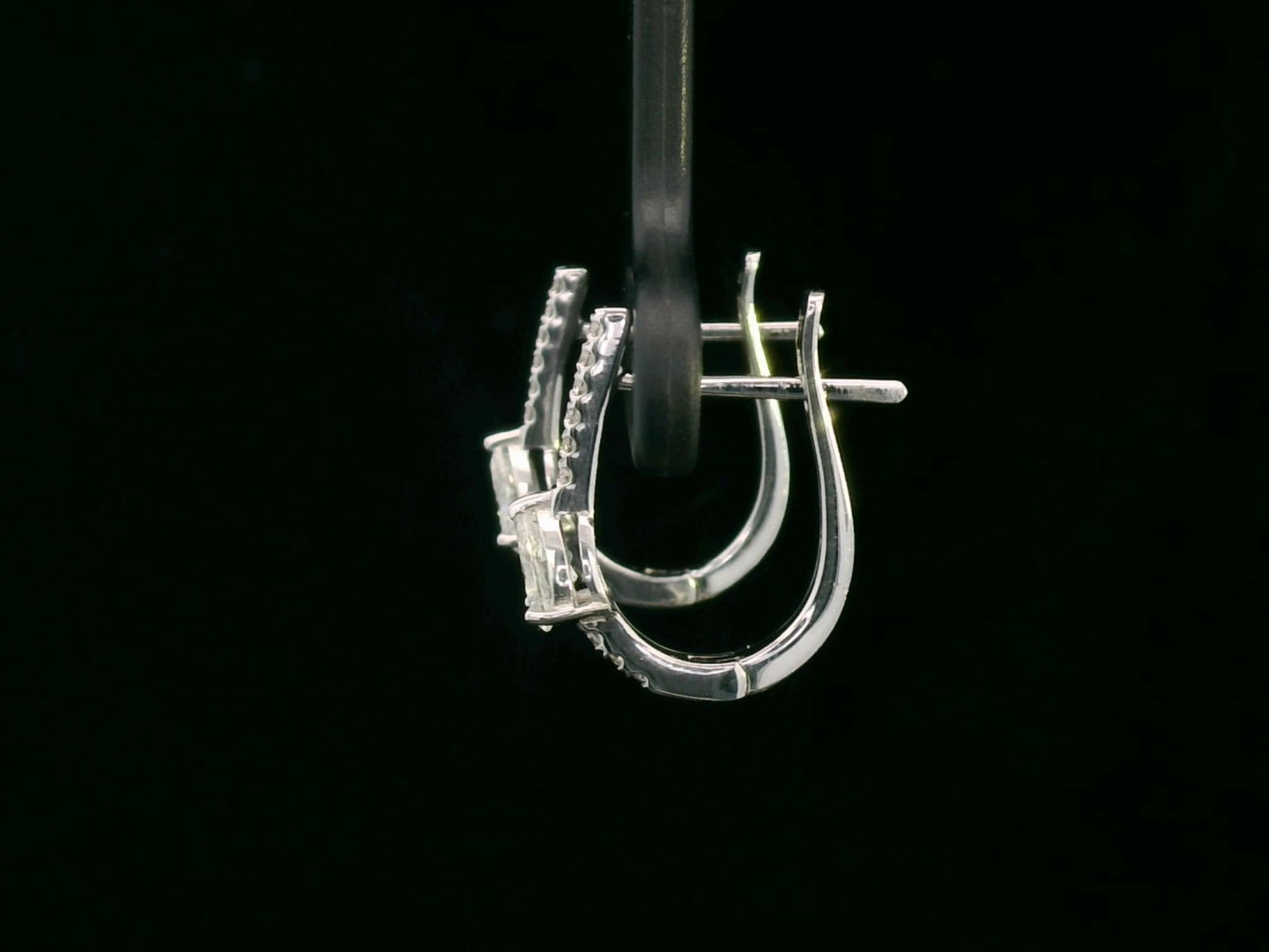 A pair of 18K gold hoop earrings featuring pear-shaped diamonds (0.41ct total) and accent diamonds (0.09ct total), elegantly designed for a timeless look.