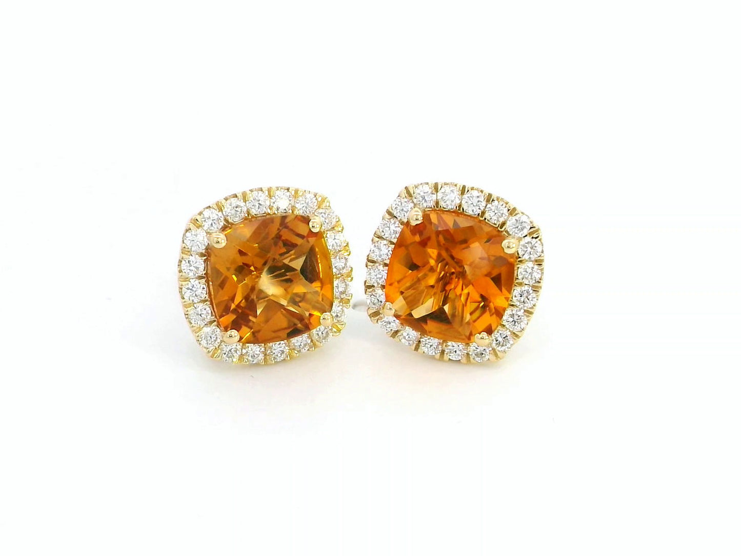 18K yellow gold cushion-cut citrine and diamond halo earrings with 3.91 carats of citrine and 0.57 carats of diamonds.