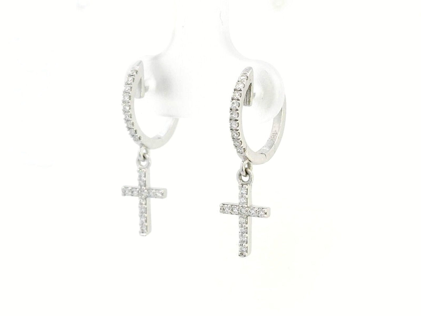 18K gold huggie hoop earrings with a 0.22-carat diamond cross charm, featuring pavé-set diamonds and a secure hinged snap closure. Elegant and meaningful.