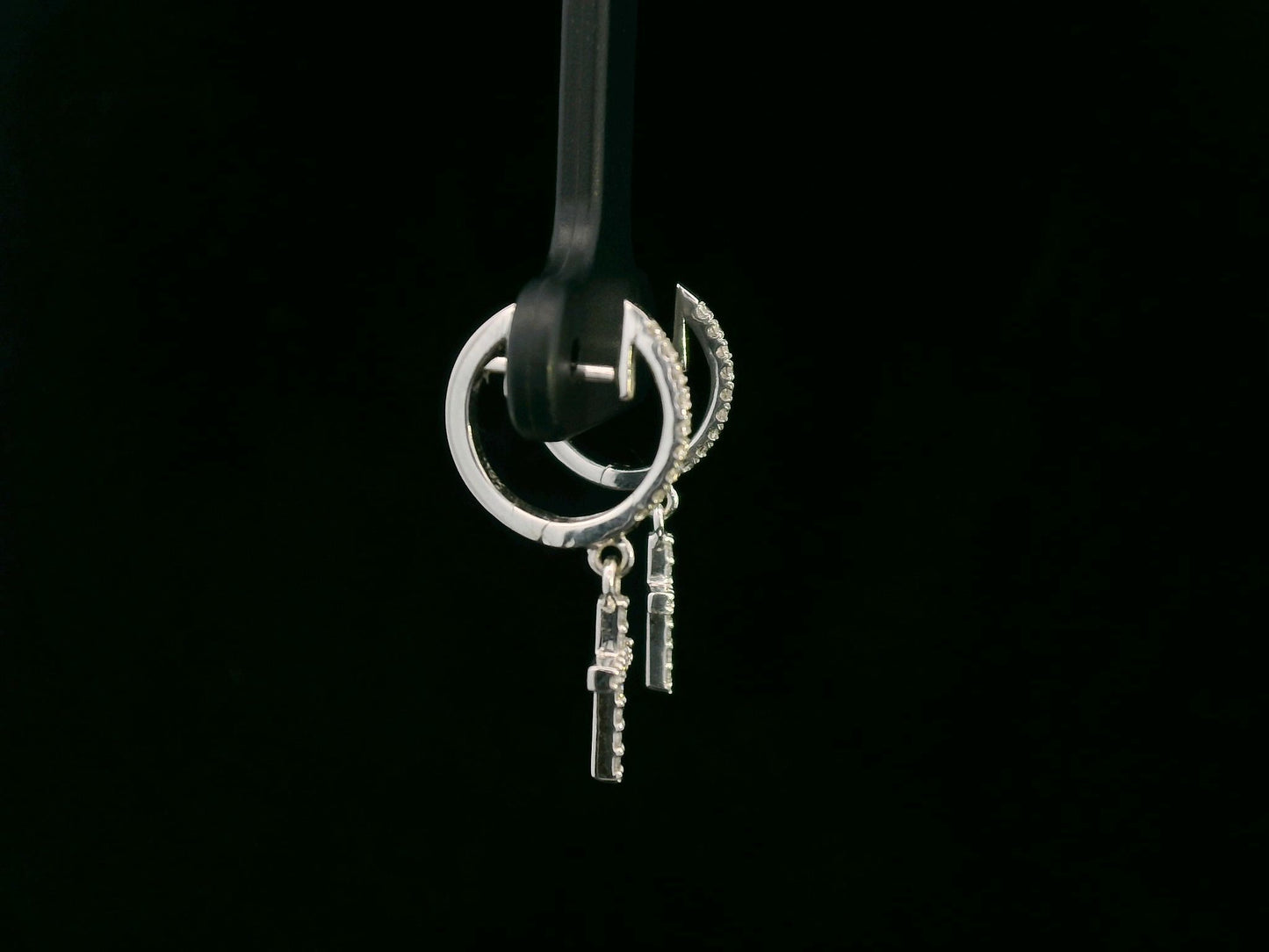 18K gold huggie hoop earrings with a 0.22-carat diamond cross charm, featuring pavé-set diamonds and a secure hinged snap closure. Elegant and meaningful.