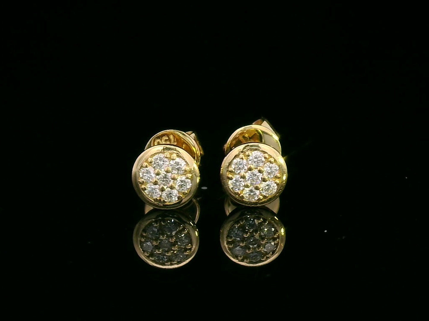 18K gold diamond cluster stud earrings featuring 0.14 carats of round diamonds in a bezel setting, secured with butterfly push-backs.