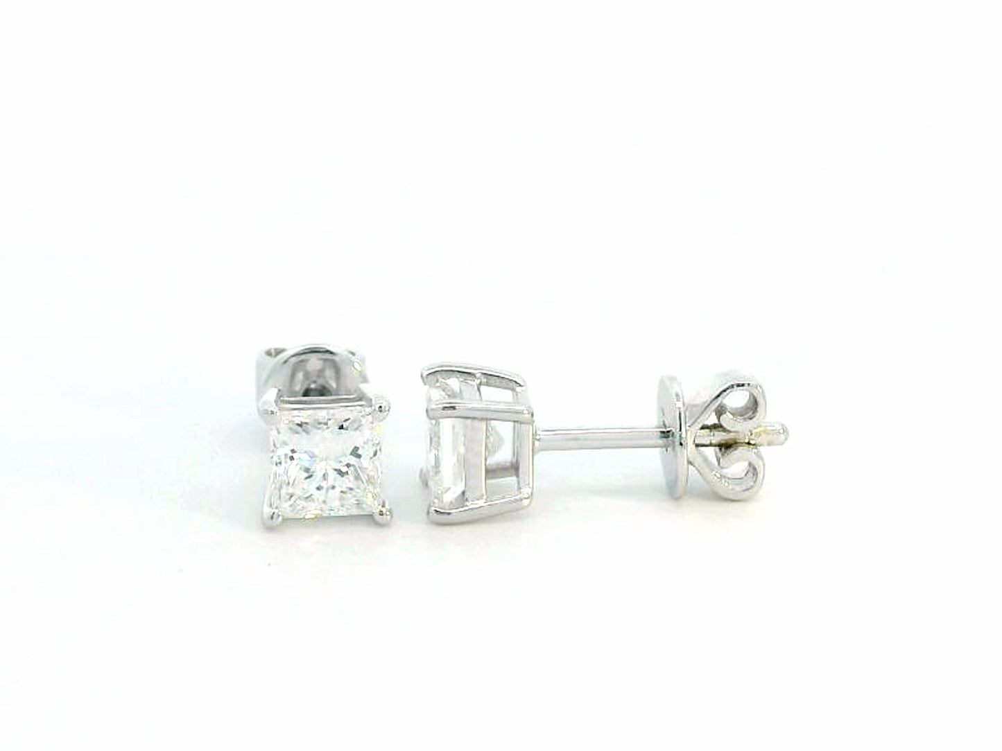 Princess-cut diamond solitaire stud earrings in 18K white gold, 1.01 carat total, GIA certified.