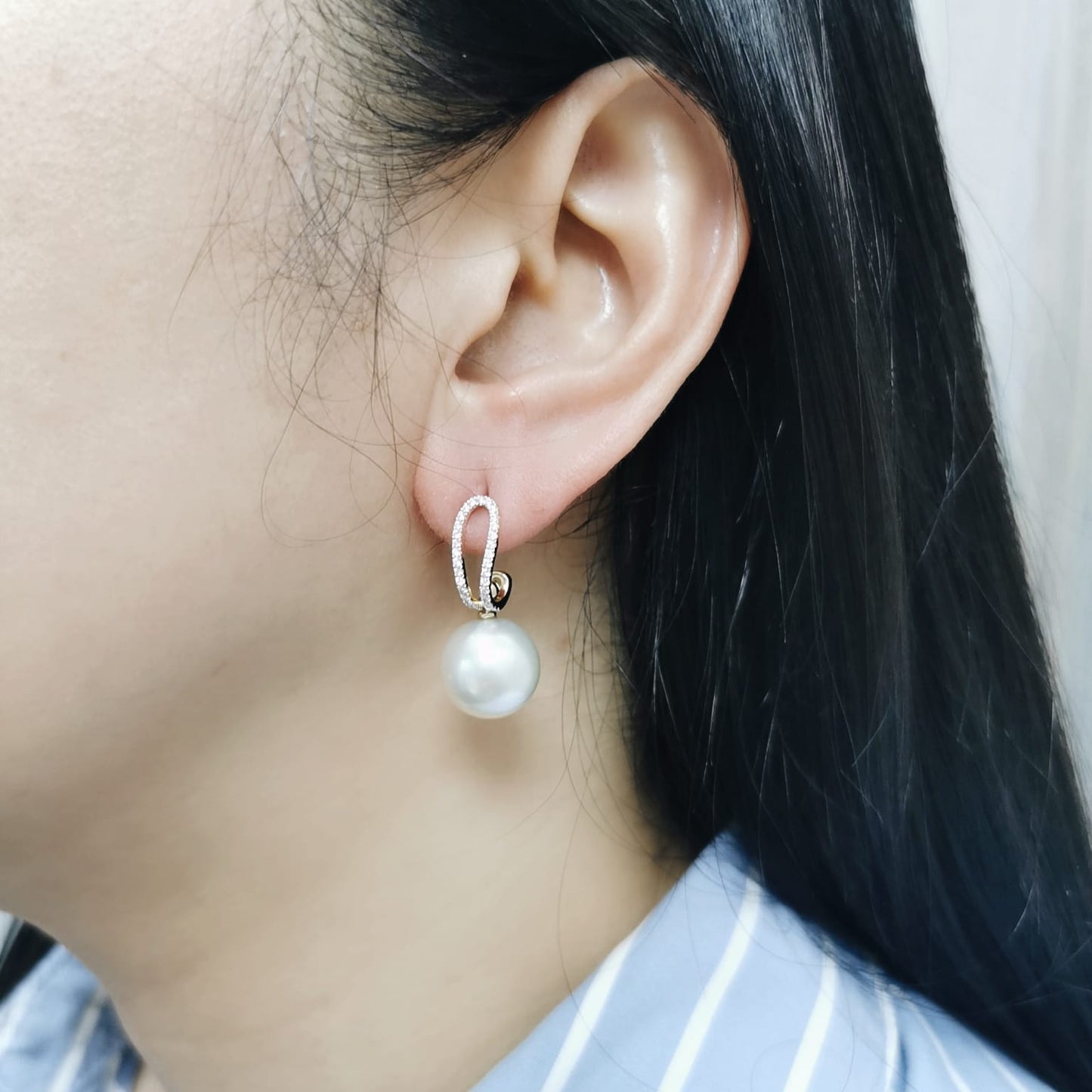 Elegant 18K gold drop earrings with South Sea white pearls (9x13mm) and 0.29ct diamond accents.