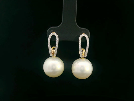 Elegant 18K gold drop earrings with South Sea white pearls (9x13mm) and 0.29ct diamond accents.