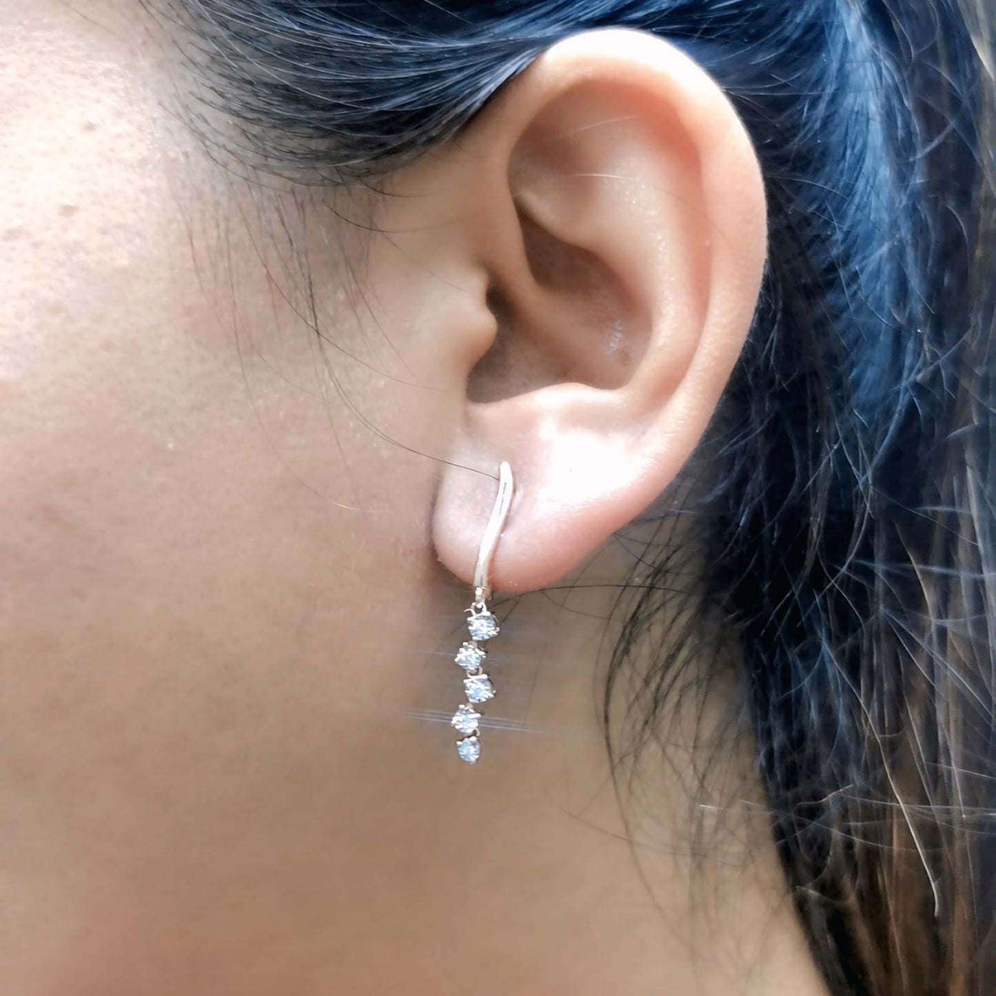 18K gold diamond drop earrings with huggie hoop closure and dangling round-cut diamonds, minimalist and elegant design.