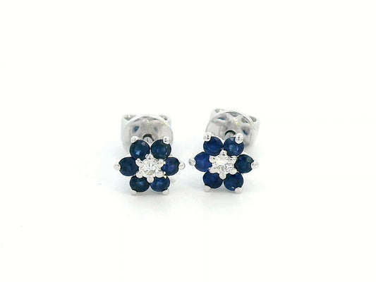 Elegant 18K gold sapphire and diamond flower stud earrings featuring 0.33 carats of blue sapphires and 0.05 carats of diamonds. A timeless floral design.