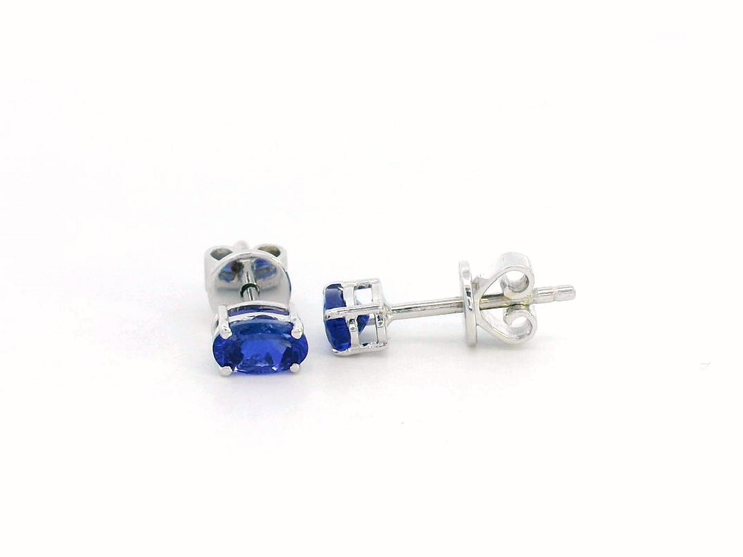 18K gold oval Tanzanite earrings featuring 0.62 carats of vibrant December birthstone in a dainty minimalist design – perfect for stacking and everyday wear.