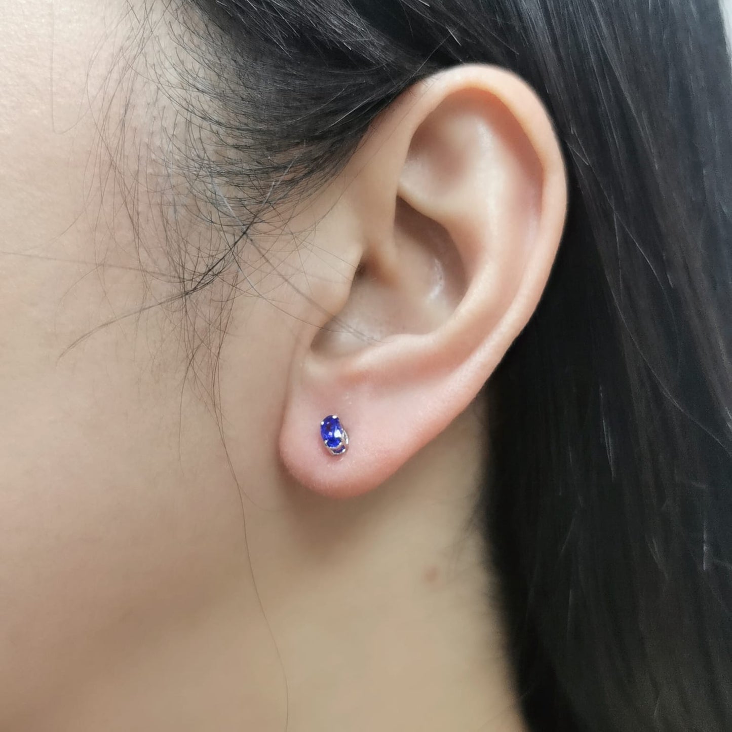 18K gold oval Tanzanite earrings featuring 0.62 carats of vibrant December birthstone in a dainty minimalist design – perfect for stacking and everyday wear.