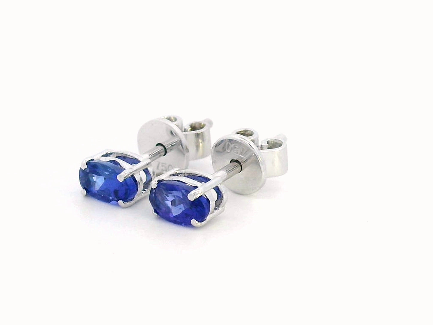 18K gold oval Tanzanite earrings featuring 0.62 carats of vibrant December birthstone in a dainty minimalist design – perfect for stacking and everyday wear.