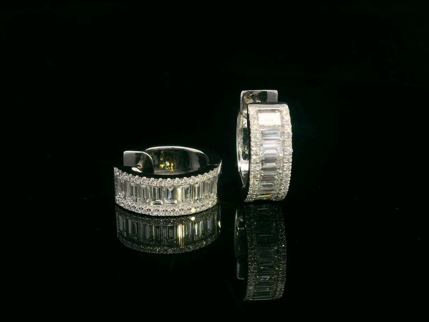 18K gold huggie hoop earrings with 1.58ct baguette and round diamonds. Elegant and timeless.