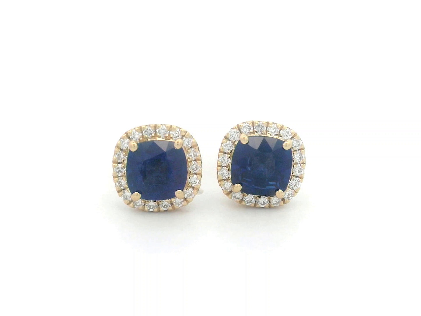 18K gold earrings with cushion-cut Blue Sapphires (1.25ct), framed by a 0.17ct diamond halo, exuding elegance and timeless luxury.