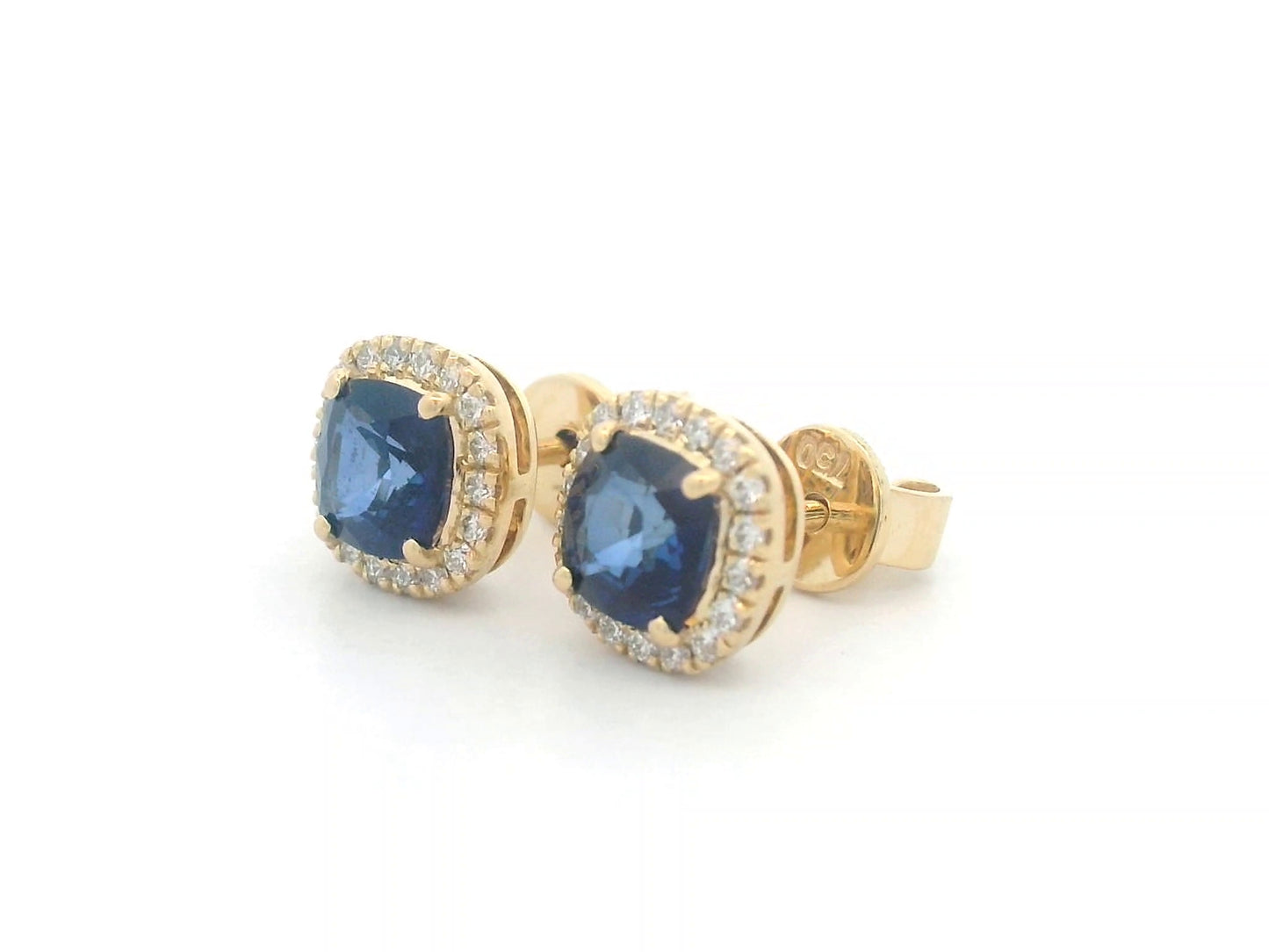 18K gold earrings with cushion-cut Blue Sapphires (1.25ct), framed by a 0.17ct diamond halo, exuding elegance and timeless luxury.