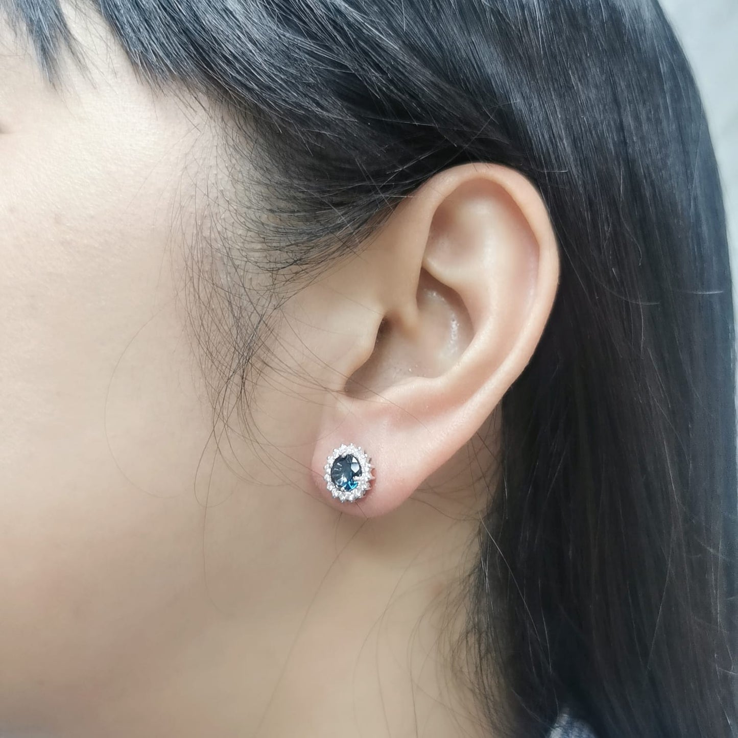 18K white gold earrings featuring London Blue Topaz with a diamond halo, totaling 1.91 carats of topaz and 0.36 carats of diamonds.