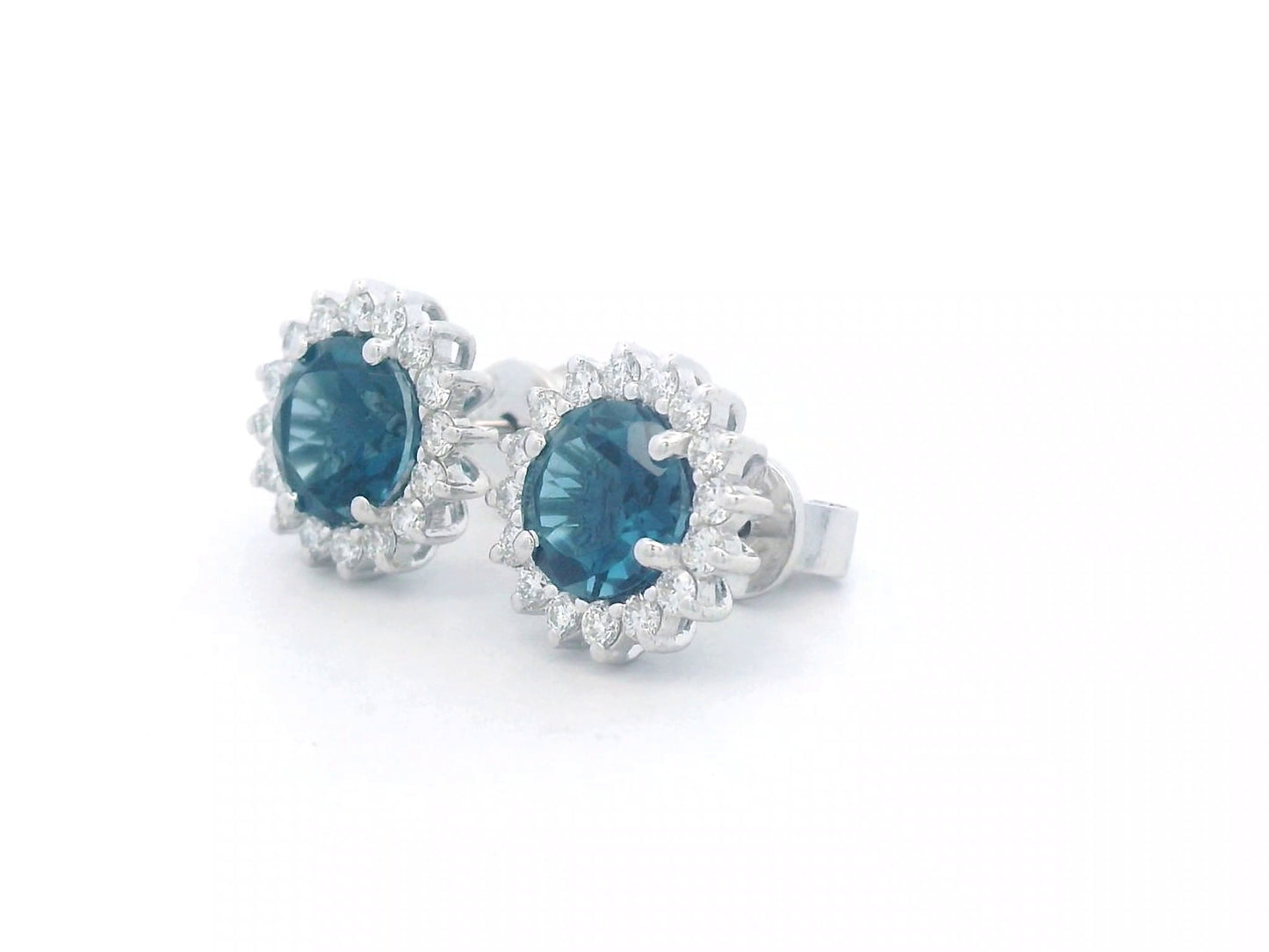 18K white gold earrings featuring London Blue Topaz with a diamond halo, totaling 1.91 carats of topaz and 0.36 carats of diamonds.