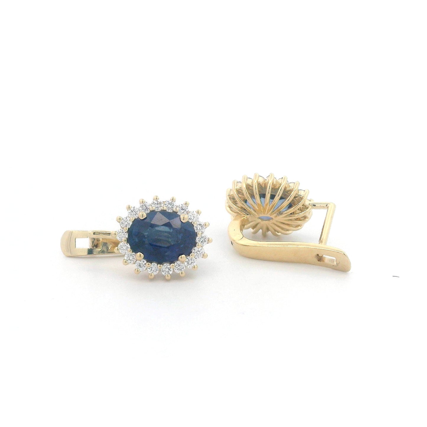 18K gold earrings featuring oval-cut Blue Sapphires (4.36ct) surrounded by a 0.56ct diamond halo, secured with hinged lever-back closures for a comfortable and elegant fit.