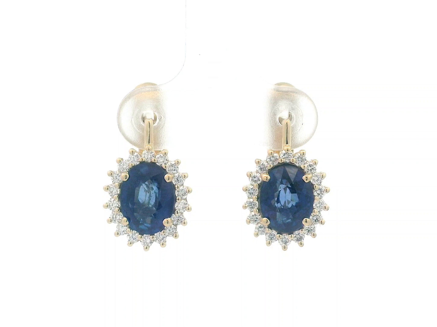 18K gold earrings featuring oval-cut Blue Sapphires (4.36ct) surrounded by a 0.56ct diamond halo, secured with hinged lever-back closures for a comfortable and elegant fit.