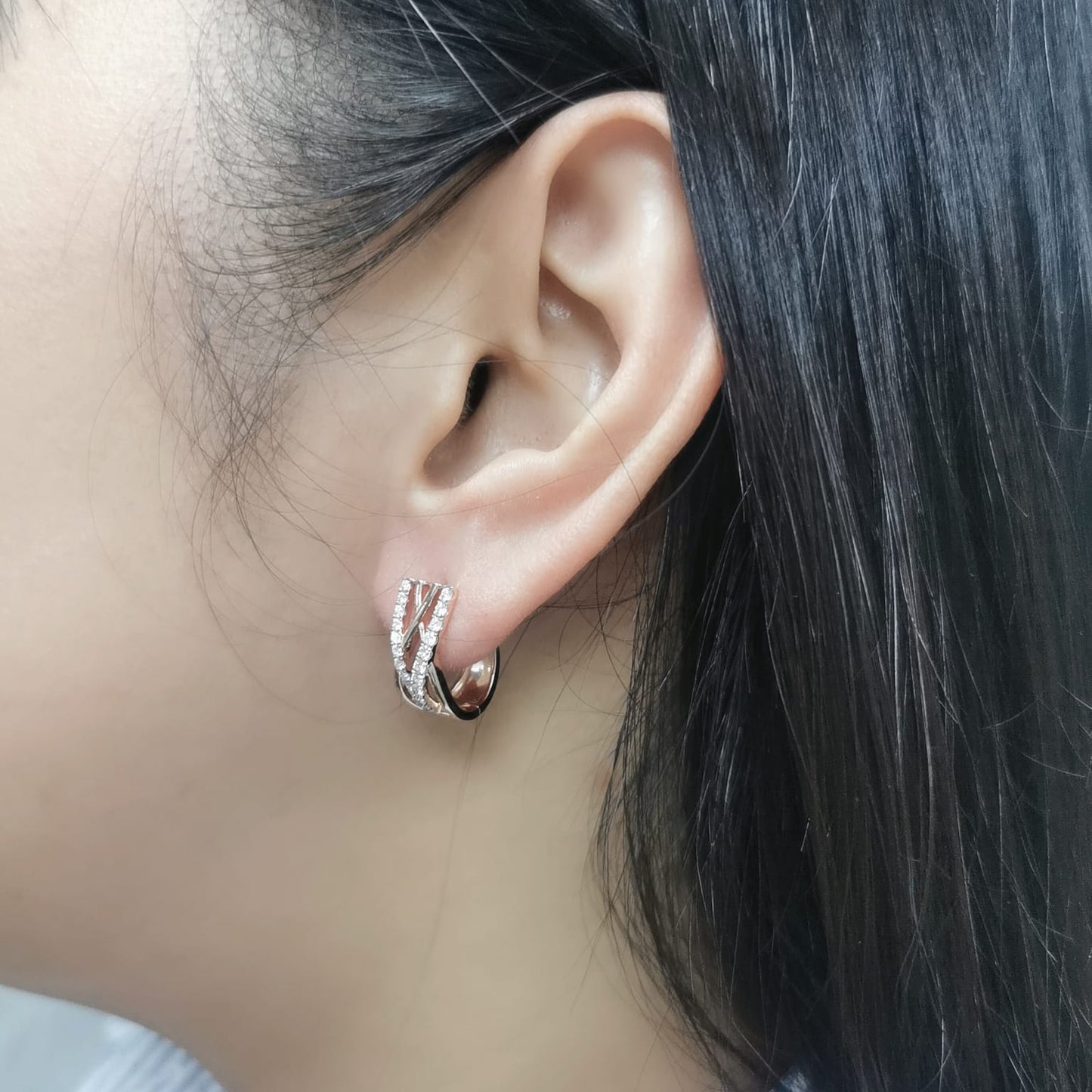 18K gold crisscross diamond huggie earrings, featuring a sleek, contemporary design with 0.52 carats of brilliant diamonds.