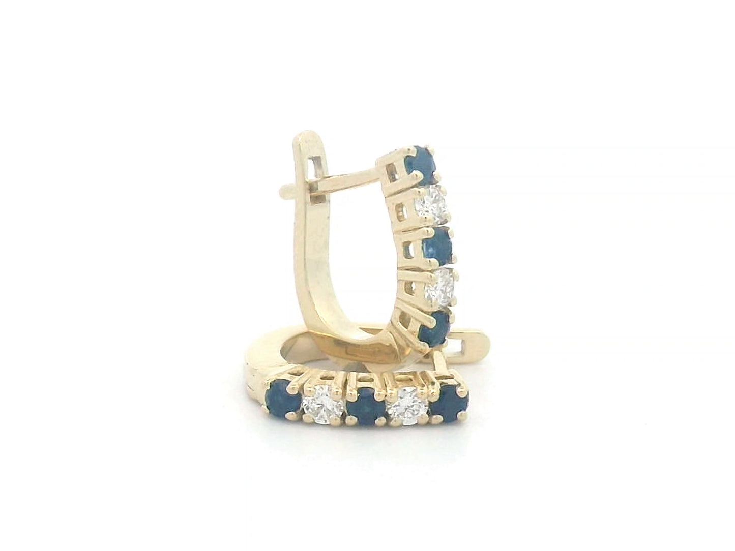 18K gold huggie hoop earrings set with deep blue sapphires and diamonds, offering a refined and elegant look.