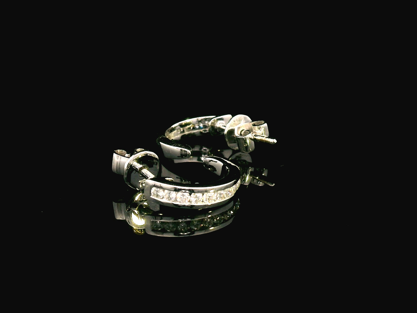 18K gold diamond huggie hoop earrings with channel-set diamonds and butterfly push-back closure.