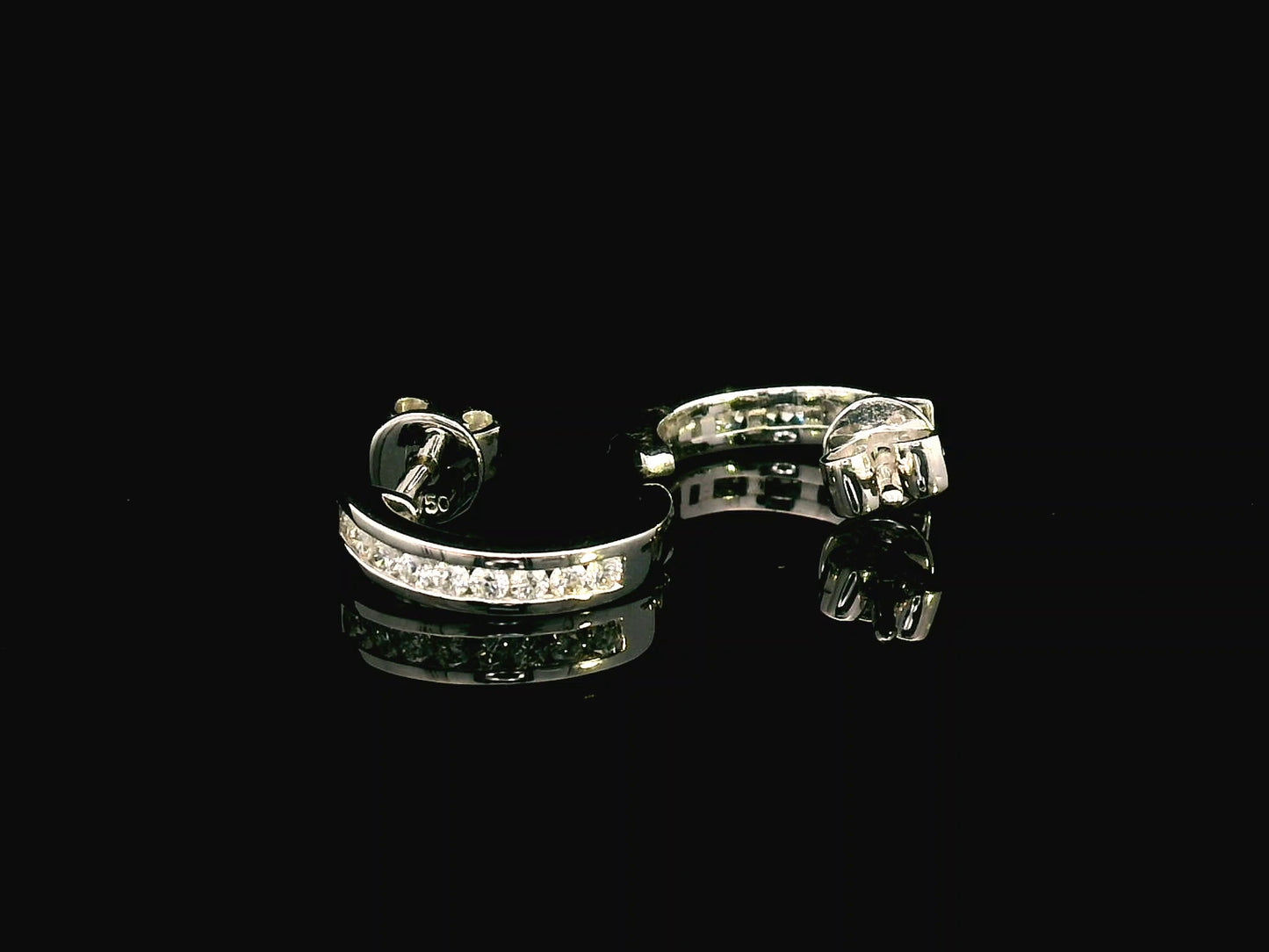 18K gold diamond huggie hoop earrings with channel-set diamonds and butterfly push-back closure.