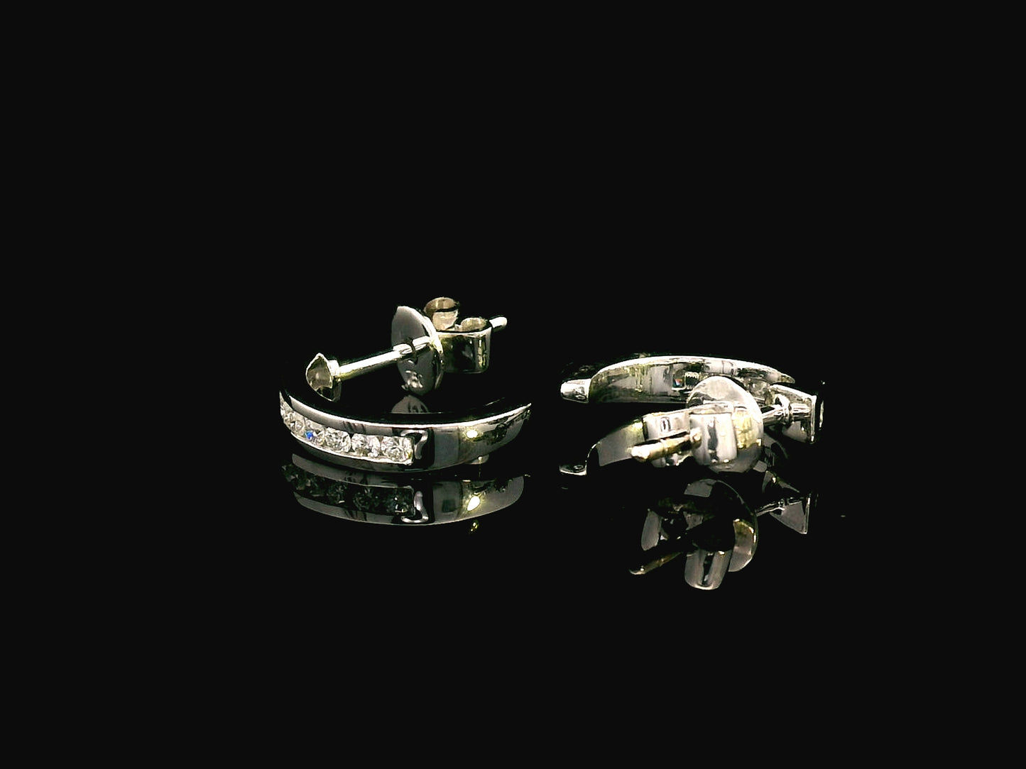 18K gold diamond huggie hoop earrings with channel-set diamonds and butterfly push-back closure.