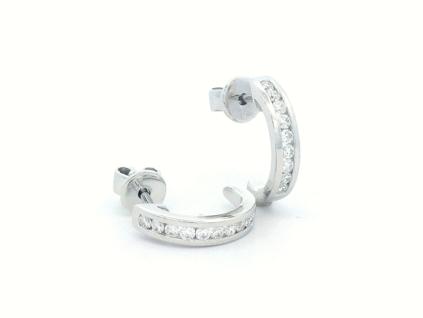 18K gold diamond huggie hoop earrings with channel-set diamonds and butterfly push-back closure.