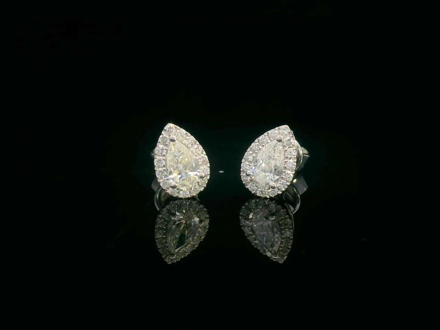 Pear-shaped diamond halo stud earrings in 18K white gold with 0.55 carats total diamond weight