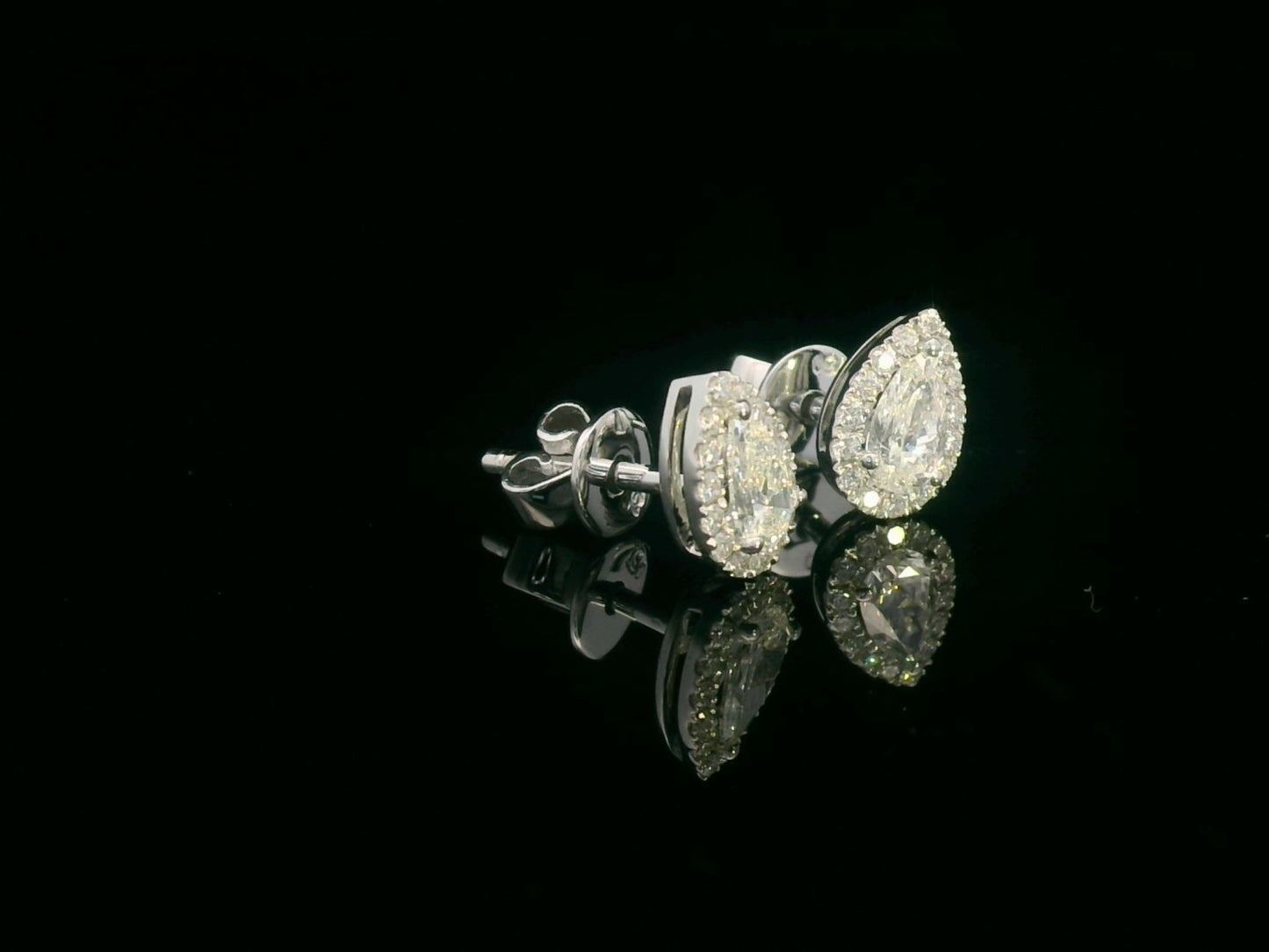 Pear-shaped diamond halo stud earrings in 18K white gold with 0.55 carats total diamond weight