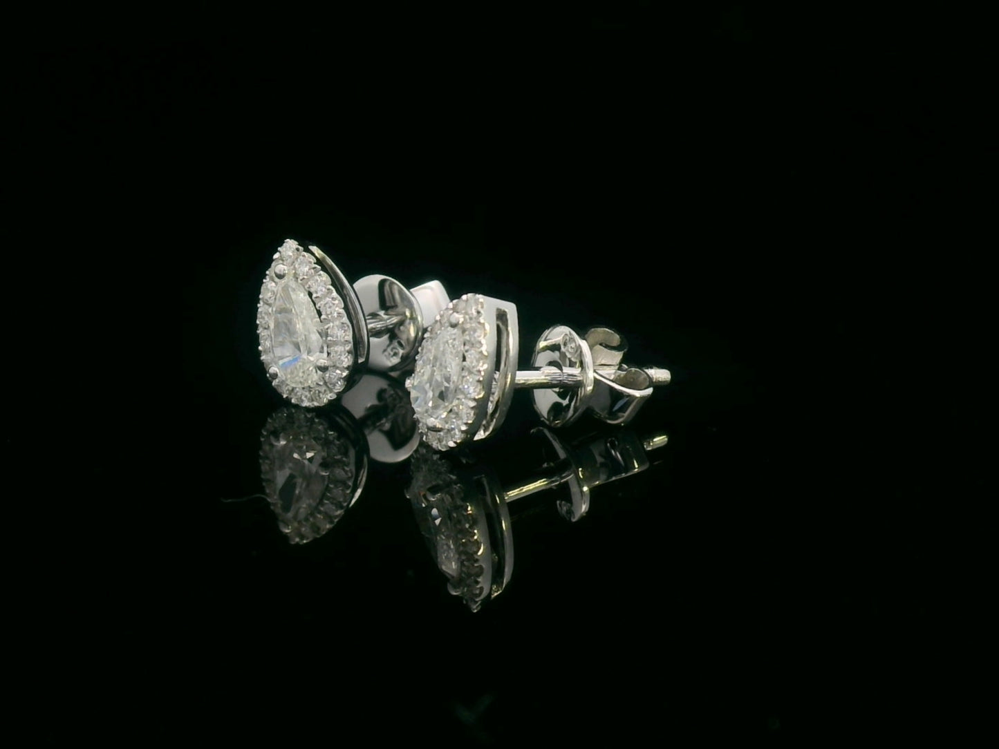 Pear-shaped diamond halo stud earrings in 18K white gold with 0.55 carats total diamond weight