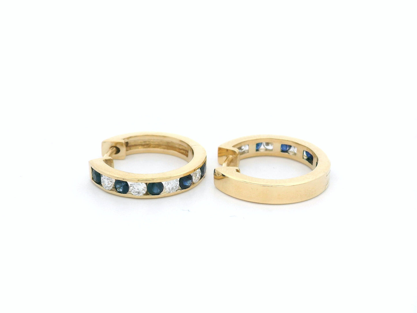 18K gold sapphire and diamond hoop earrings with alternating gemstones.