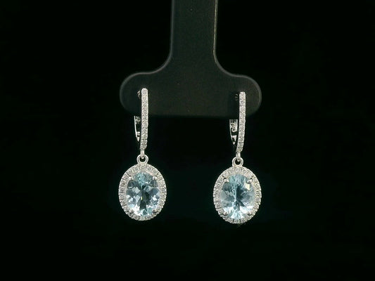 18K gold drop earrings with oval aquamarine center stones and diamond halo design