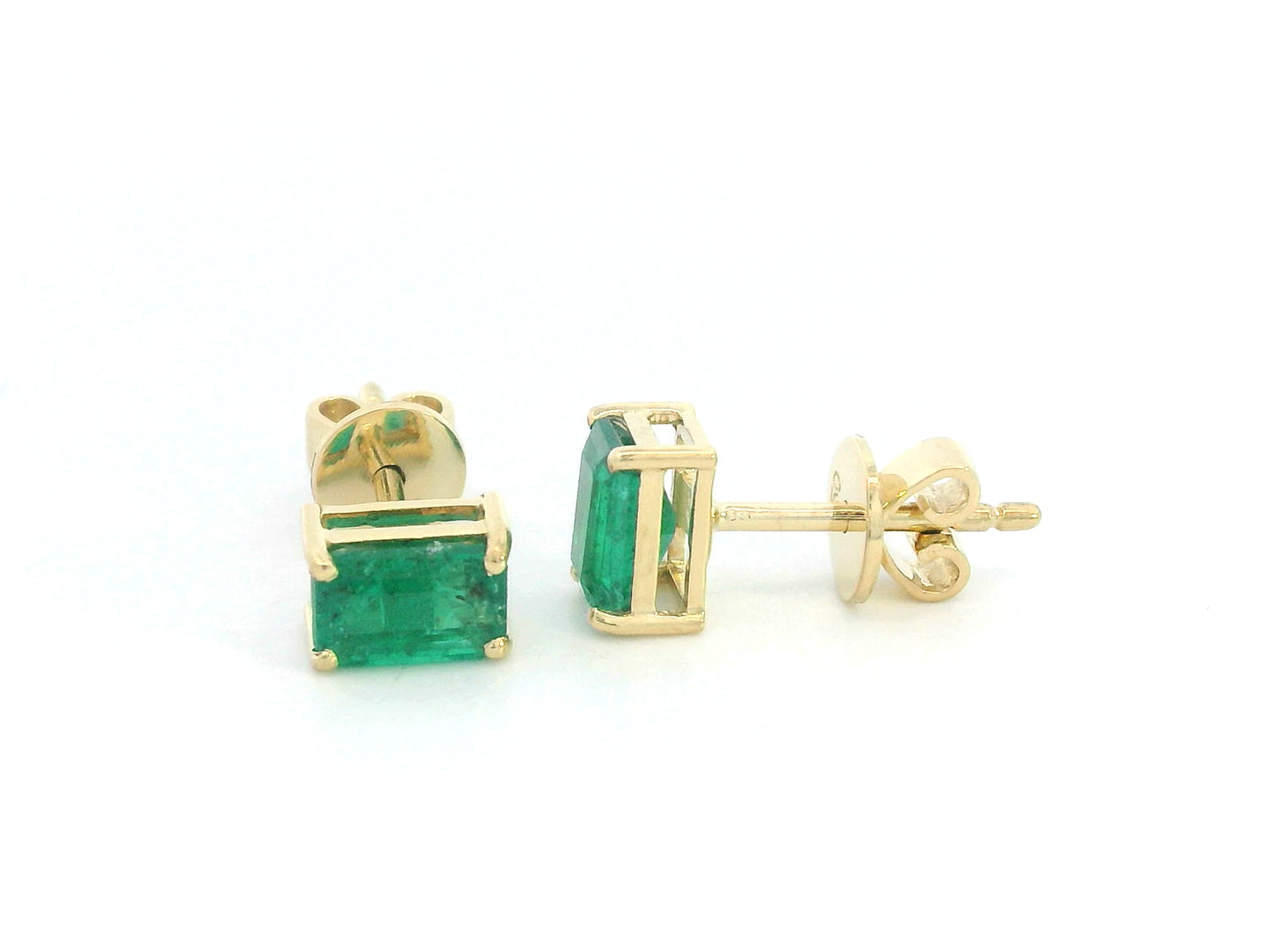 18K yellow gold emerald-cut emerald stud earrings with four-prong setting and butterfly backs.