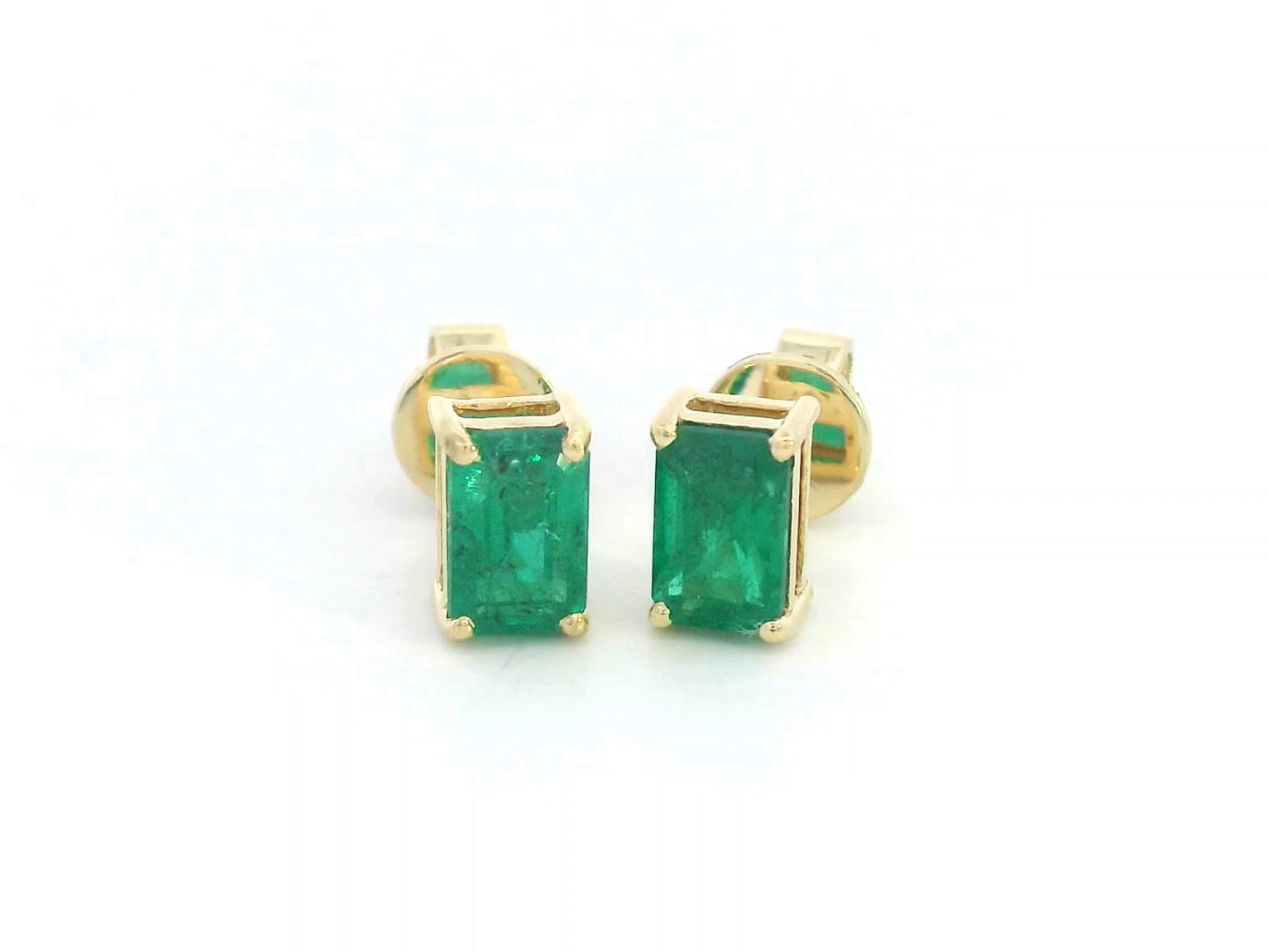 18K yellow gold emerald-cut emerald stud earrings with four-prong setting and butterfly backs.