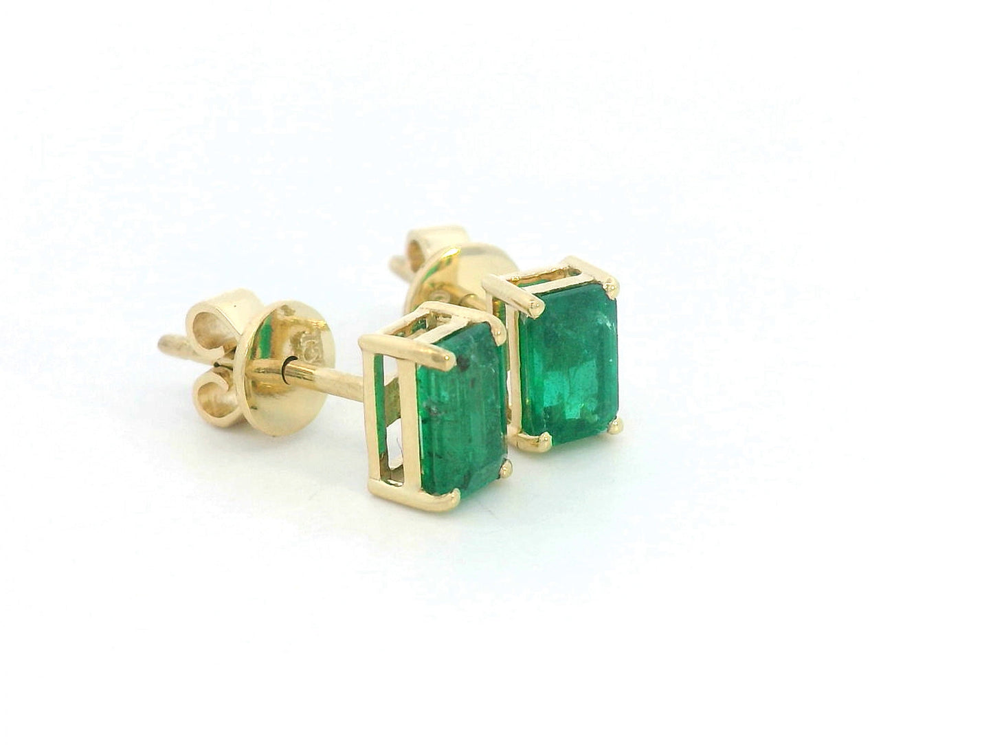 18K yellow gold emerald-cut emerald stud earrings with four-prong setting and butterfly backs.