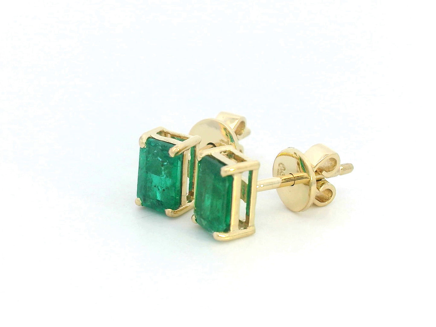 18K yellow gold emerald-cut emerald stud earrings with four-prong setting and butterfly backs.