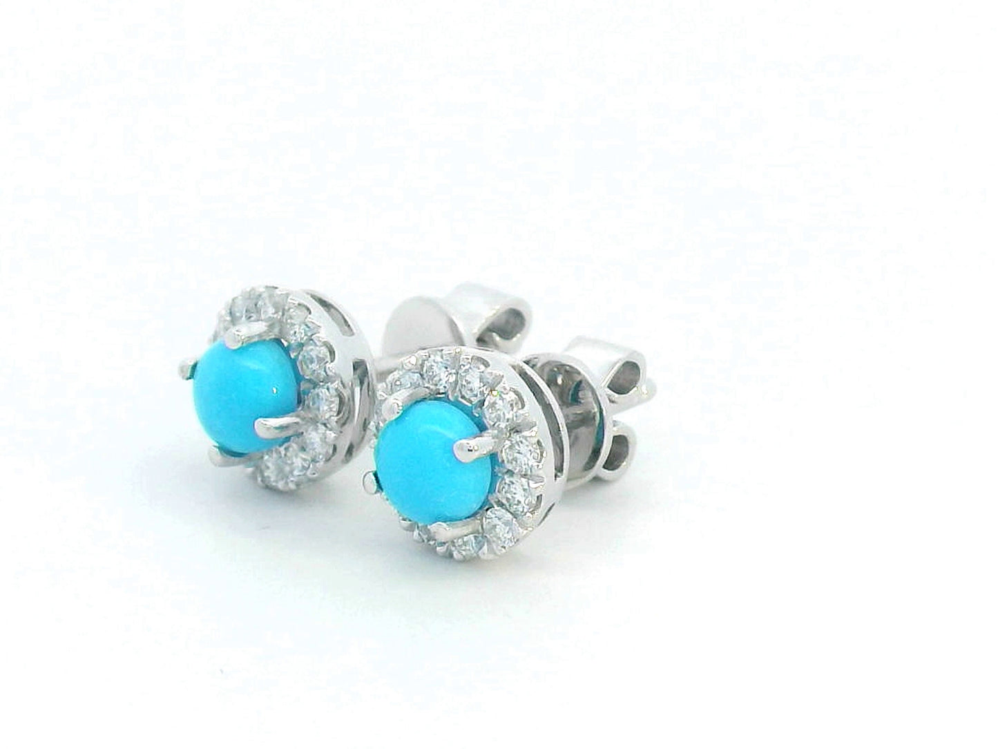 18K white gold stud earrings with round turquoise centers and diamond halo accents.