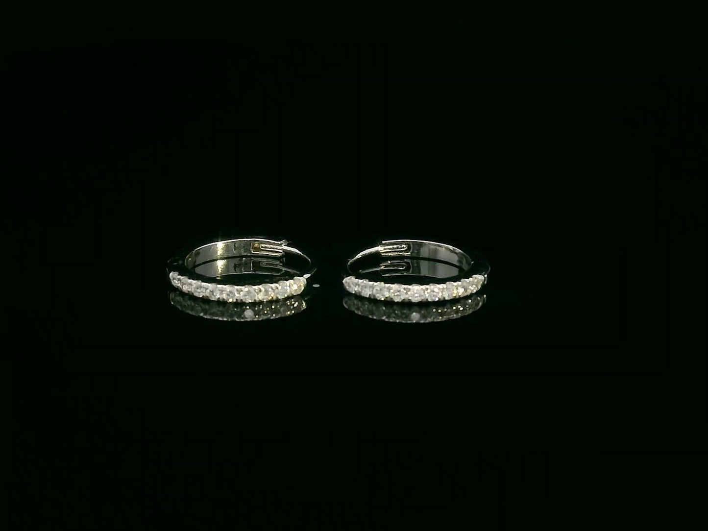 Minimalist 18K gold huggie earrings with 0.10 carat round diamonds in a sleek everyday hoop design