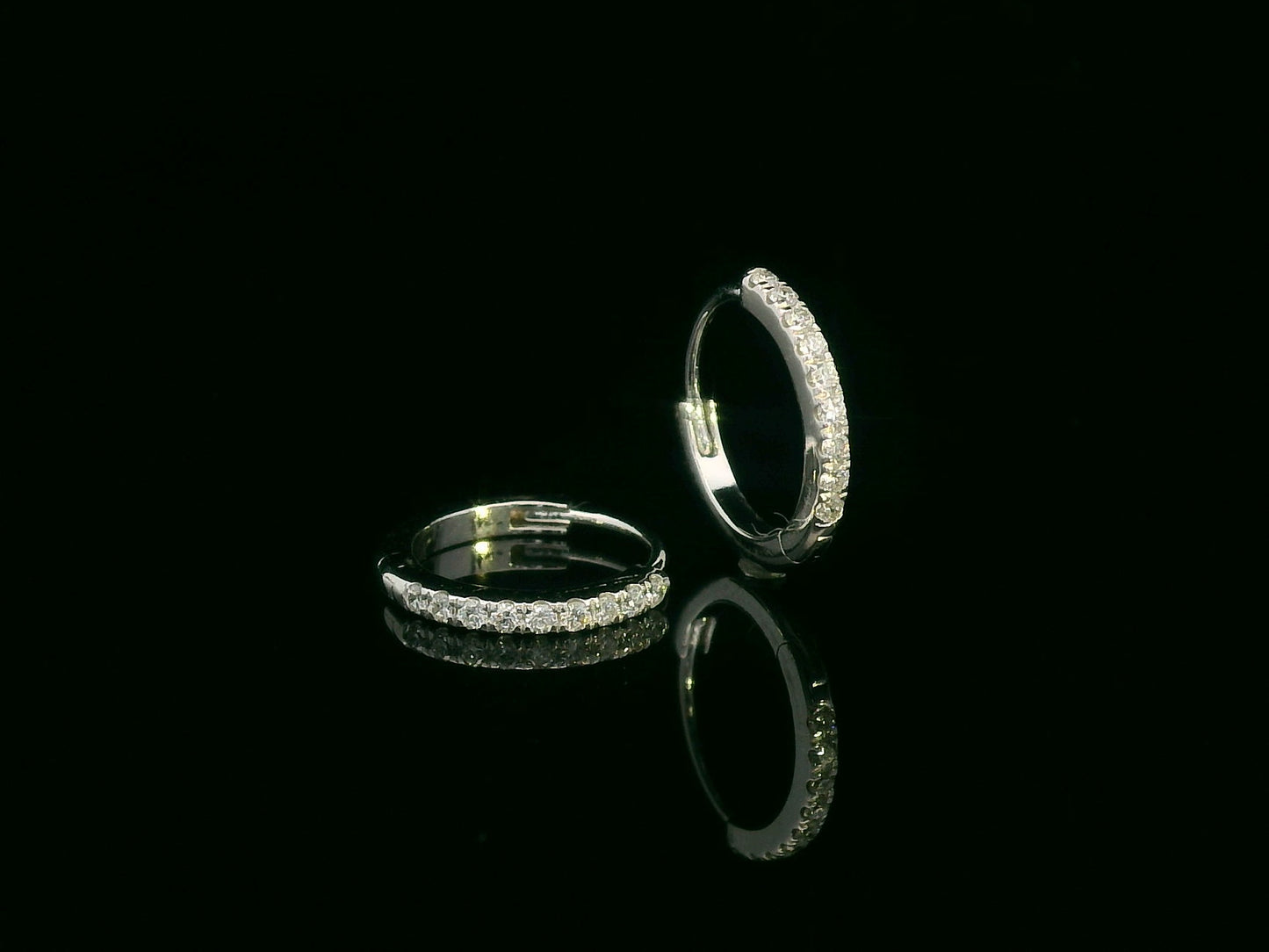 Minimalist 18K gold huggie earrings with 0.10 carat round diamonds in a sleek everyday hoop design