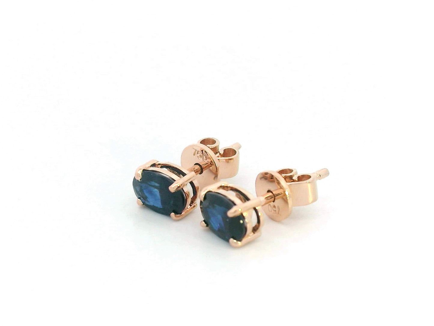 18K rose gold stud earrings with oval-cut natural blue sapphires totaling 1.06 carats, four-prong set with butterfly push backs.