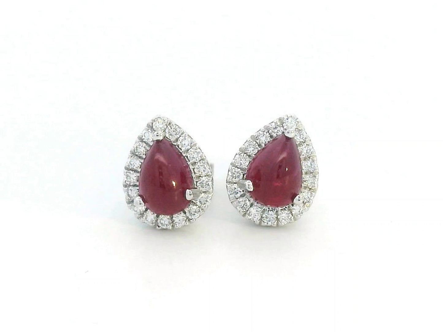 18K gold ruby earrings with pear-shaped 2.21 CT cabochon rubies and diamond halo accents.
